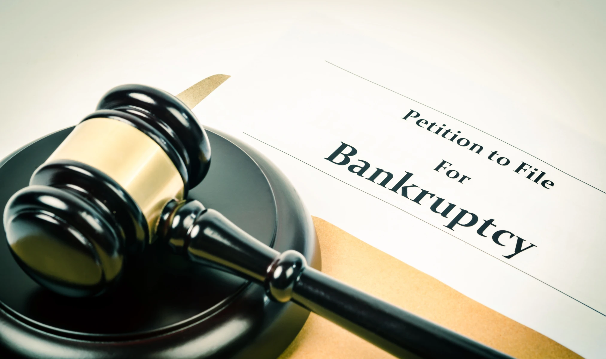 Professional bankruptcy law consultation - attorney reviewing financial documents with client seeking debt relief
